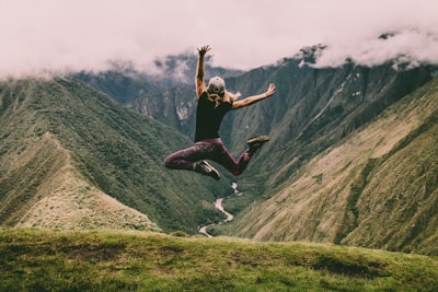 Woman jumping for joy on a mountain top